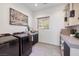 Well-lit laundry room with modern washer and dryer, sink, and ample storage space for convenience at 1 Boulderback Dr, Henderson, NV 89012