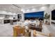 Spacious living area flows to a modern kitchen with city views, a fireplace, and stylish furnishings at 1 Boulderback Dr, Henderson, NV 89012