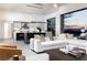Bright open-concept living room flowing seamlessly into a modern kitchen with a stunning sunset view at 1 Boulderback Dr, Henderson, NV 89012