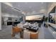 Bright open-concept living room featuring a fireplace, expansive windows, and a modern kitchen at 1 Boulderback Dr, Henderson, NV 89012