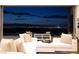 Elegant living room with comfortable seating and a panoramic view of the city skyline at dusk at 1 Boulderback Dr, Henderson, NV 89012