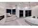 Bright bedroom featuring a cozy seating area with steps and large windows for city views at 1 Boulderback Dr, Henderson, NV 89012