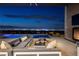 Expansive outdoor living area with a sleek pool and breathtaking city views at night at 1 Boulderback Dr, Henderson, NV 89012
