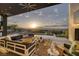 Serene outdoor living area with a pool, comfortable seating, and panoramic mountain views at sunset at 1 Boulderback Dr, Henderson, NV 89012