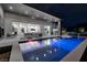 Stunning backyard featuring a modern pool, outdoor kitchen, and seamless indoor-outdoor living space at 1 Boulderback Dr, Henderson, NV 89012