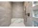 Luxurious shower with tiled walls, a built-in bench, and modern fixtures at 1 Boulderback Dr, Henderson, NV 89012