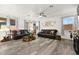 Spacious living room with dark leather sofas, wood-look flooring and large windows at 2134 Dillons Cove Dr, Laughlin, NV 89029