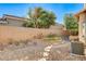 Private backyard with desert landscaping, stone pathways, and block wall for added seclusion at 29 Desert Highlands Dr, Henderson, NV 89052