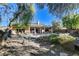 Large backyard featuring a pool, spa, covered patio, and mature trees at 29 Desert Highlands Dr, Henderson, NV 89052