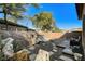 Private backyard area with mature landscaping, shed, and grilling area at 29 Desert Highlands Dr, Henderson, NV 89052