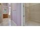 An ensuite bathroom features a walk in closet and a view of the vanity and tub at 29 Desert Highlands Dr, Henderson, NV 89052