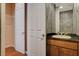 A small bathroom features a vanity with sink, mirror, and textured wall at 29 Desert Highlands Dr, Henderson, NV 89052