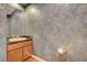 A bathroom features a vanity with sink, mirror, and textured wall at 29 Desert Highlands Dr, Henderson, NV 89052