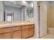Double vanity bathroom with tile countertops, wood cabinets, and large mirror at 29 Desert Highlands Dr, Henderson, NV 89052