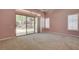 A primary bedroom features carpeted floors, ceiling fan, sliding glass door, and shuttered windows at 29 Desert Highlands Dr, Henderson, NV 89052