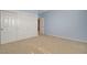Light blue bedroom featuring ample closet space, neutral carpeting, and white trim at 29 Desert Highlands Dr, Henderson, NV 89052