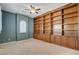 Large bedroom with ceiling fan, plantation shutters, built in bookcase, and neutral carpet at 29 Desert Highlands Dr, Henderson, NV 89052