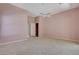 A primary bedroom features carpeted floors, ceiling fan, and doors to an ensuite bathroom at 29 Desert Highlands Dr, Henderson, NV 89052