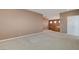 Open bedroom area featuring neutral colored walls and carpet, with view of the railing and hallway at 29 Desert Highlands Dr, Henderson, NV 89052