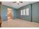 Inviting bedroom features neutral carpet, ceiling fan and shuttered windows at 29 Desert Highlands Dr, Henderson, NV 89052