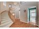 Welcoming entryway boasts a curved staircase, hardwood floors, and an abundance of natural light at 29 Desert Highlands Dr, Henderson, NV 89052