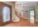 Inviting entryway features a decorative glass front door and a curved staircase leading to the upper level at 29 Desert Highlands Dr, Henderson, NV 89052