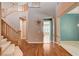 Spacious entryway boasts hardwood floors, a curved staircase, and an open layout for a grand impression at 29 Desert Highlands Dr, Henderson, NV 89052