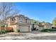 Two-story house with stone accents and a three-car garage at 29 Desert Highlands Dr, Henderson, NV 89052
