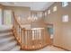 Foyer features chandelier, hardwood floors, and wood banister at 29 Desert Highlands Dr, Henderson, NV 89052