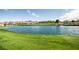 Scenic view of the golf course, with a large lake and luxury homes in the background at 29 Desert Highlands Dr, Henderson, NV 89052