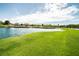 Picturesque view of the golf course with lush green grass and a serene lake at 29 Desert Highlands Dr, Henderson, NV 89052