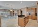 Kitchen island with seating, seamlessly connected to living area with fireplace at 29 Desert Highlands Dr, Henderson, NV 89052