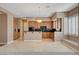 Stylish kitchen with wood cabinetry, black countertops, and stainless steel appliances at 29 Desert Highlands Dr, Henderson, NV 89052