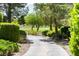 Path through lush landscaping leads to the golf course, offering a tranquil and scenic view at 29 Desert Highlands Dr, Henderson, NV 89052