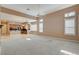 Spacious living room with a ceiling fan and lots of natural light from large windows at 29 Desert Highlands Dr, Henderson, NV 89052