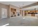 Open concept living room with a fireplace and seamless flow into the kitchen area at 29 Desert Highlands Dr, Henderson, NV 89052