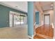 Inviting living room with a chandelier and sliding glass doors to the outdoor area at 29 Desert Highlands Dr, Henderson, NV 89052
