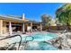Inviting pool and spa area with rock accents and lush landscaping, perfect for relaxation at 29 Desert Highlands Dr, Henderson, NV 89052