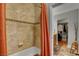 Bathroom with tan tile, tub, and walk-in closet at 5100 Jordan Frey St # 203, Las Vegas, NV 89130