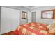 Bedroom with red and tan bedding and double door closet at 5100 Jordan Frey St # 203, Las Vegas, NV 89130