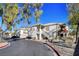 Exterior view of building, showing garage and landscaping at 5100 Jordan Frey St # 203, Las Vegas, NV 89130