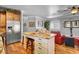 Island kitchen with granite countertop, stainless steel appliances, and hardwood floor at 5100 Jordan Frey St # 203, Las Vegas, NV 89130