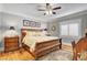 Spacious main bedroom with hardwood floors, large windows, and ceiling fan at 5100 Jordan Frey St # 203, Las Vegas, NV 89130