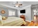 Main bedroom with hardwood floors, mounted TV, and ceiling fan at 5100 Jordan Frey St # 203, Las Vegas, NV 89130