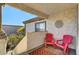 Relaxing patio with two red chairs and an outdoor rug at 5100 Jordan Frey St # 203, Las Vegas, NV 89130