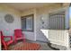 Private patio with red chairs and patterned rug at 5100 Jordan Frey St # 203, Las Vegas, NV 89130