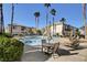 Relaxing pool area with patio furniture and palm trees at 5100 Jordan Frey St # 203, Las Vegas, NV 89130