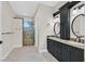Luxury bathroom featuring dark cabinetry, dual sinks, and a glass-enclosed shower at 5790 Aspen Falls Cir, Las Vegas, NV 89149
