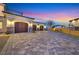A long driveway leads to a three-car garage and a home with beautiful landscaping at 5790 Aspen Falls Cir, Las Vegas, NV 89149