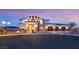 Stunning two-story home with a three-car garage and stone accents, beautifully lit at dusk at 5790 Aspen Falls Cir, Las Vegas, NV 89149